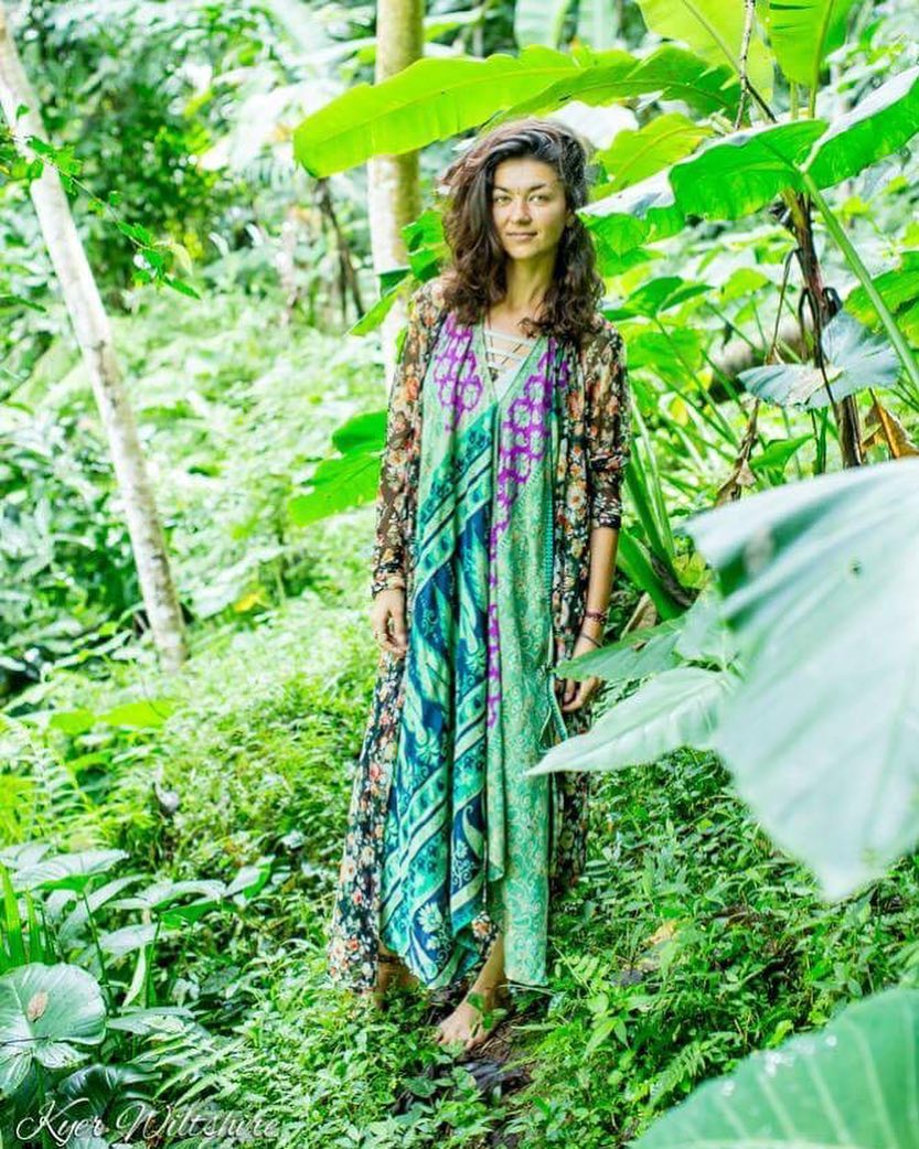 Iryna Oksaniuk standing among tropical greenery, photographed by Kyer Wiltshire